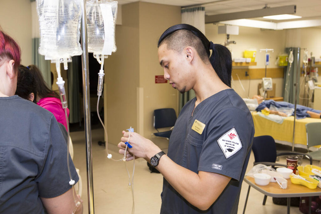Nursing student practicing techniques in a nursing lab