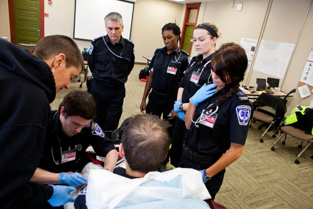 Paramedicine instructor showing student a technique