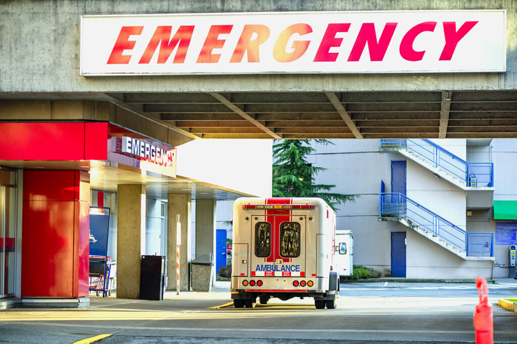 Ambulance driving up to emergency entrance at hospital