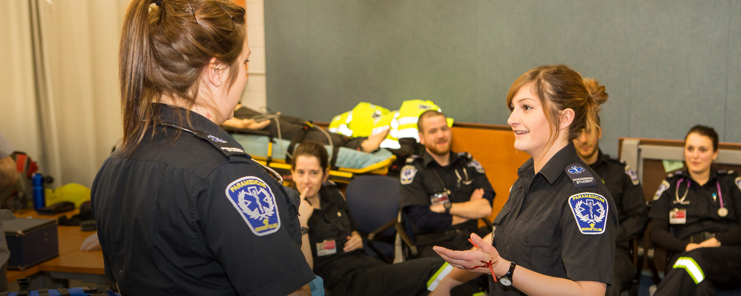 Paramedicine students talking to each other in classroom