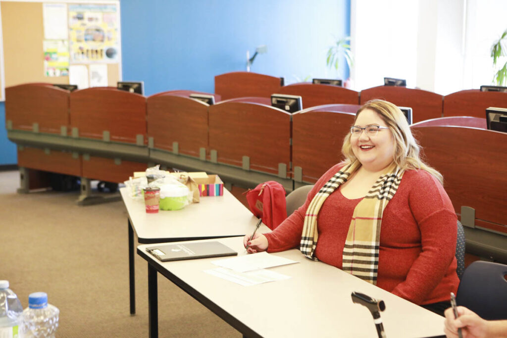 Smiling woman sitting at a table