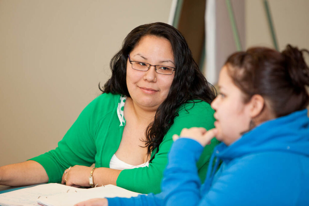 Two women talking in a classroom