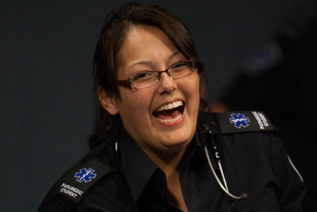 Woman in a paramedic outfit laughing