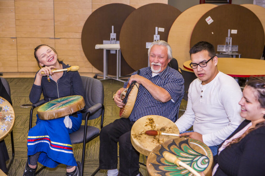 Indigenous elder in a drum circle