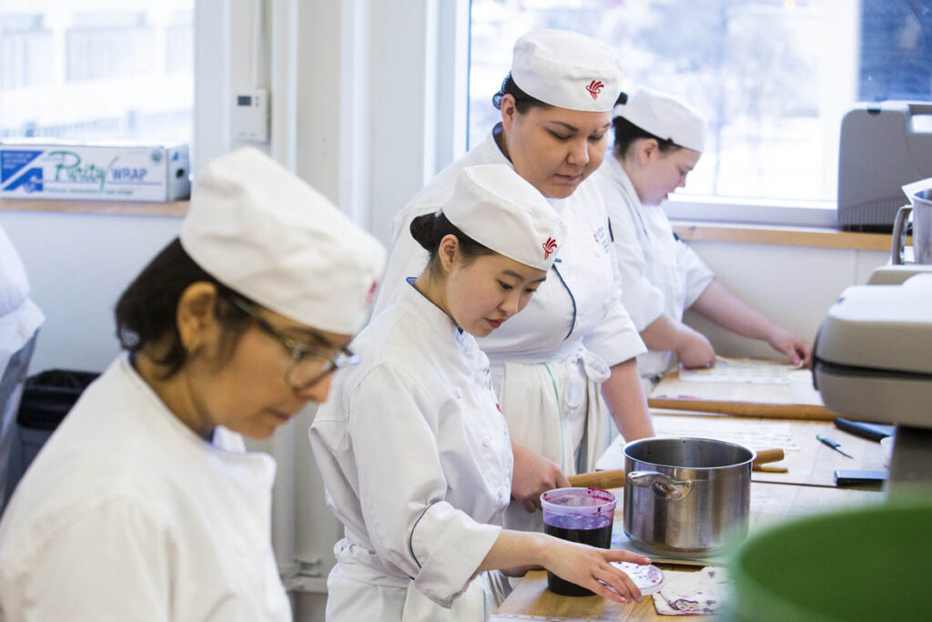 Baking students in a kitchen