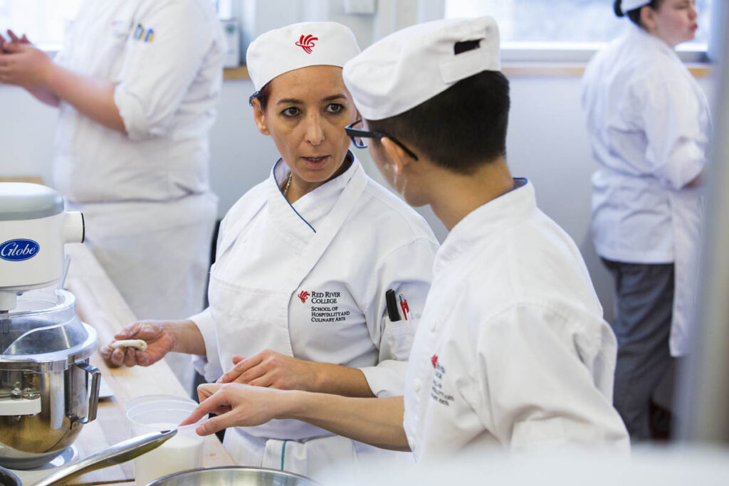 Two bakers talking to one another