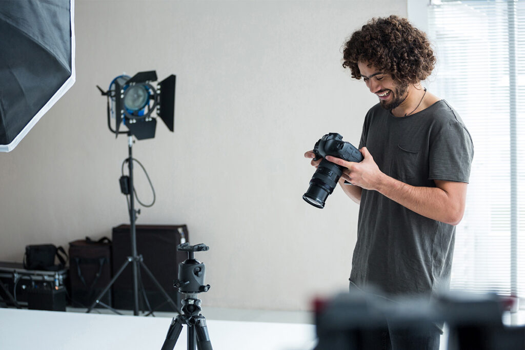Man holding a camera in a photo studio