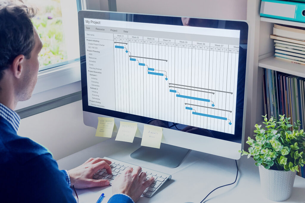 Person looking at a computer screen showing a project timeline