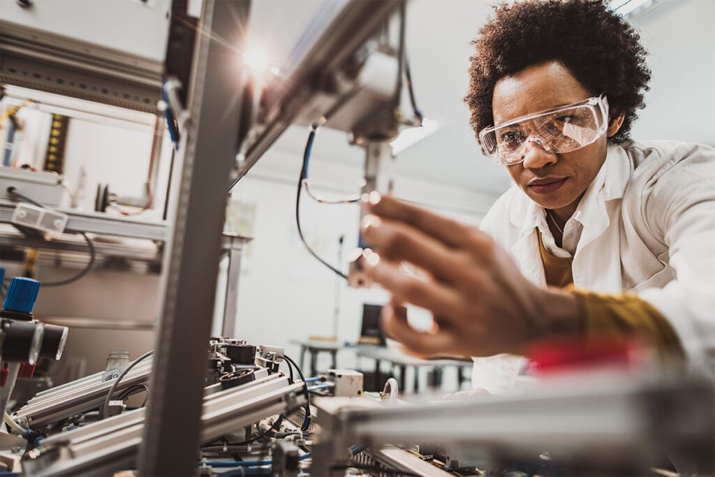 Woman in a lab working with a machining device