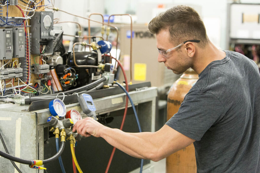 Student looking at pressure gauges in a lab