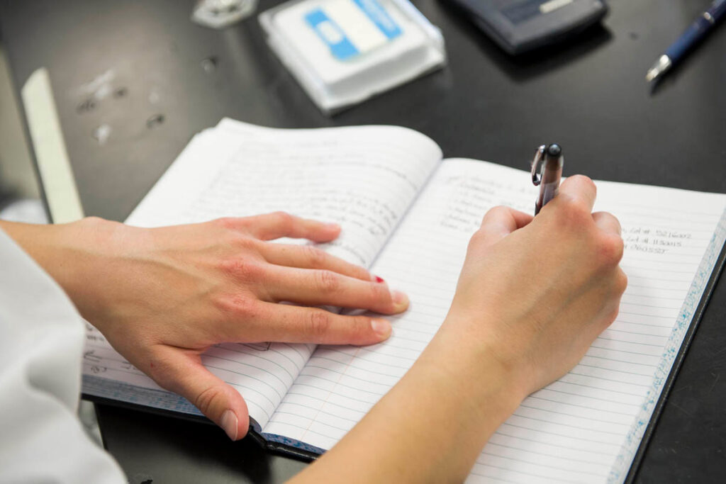 Student taking notes in a notebook