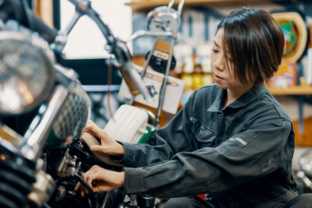 Woman working on a motorcycle