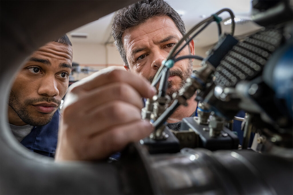 Mechanics inspecting an engine