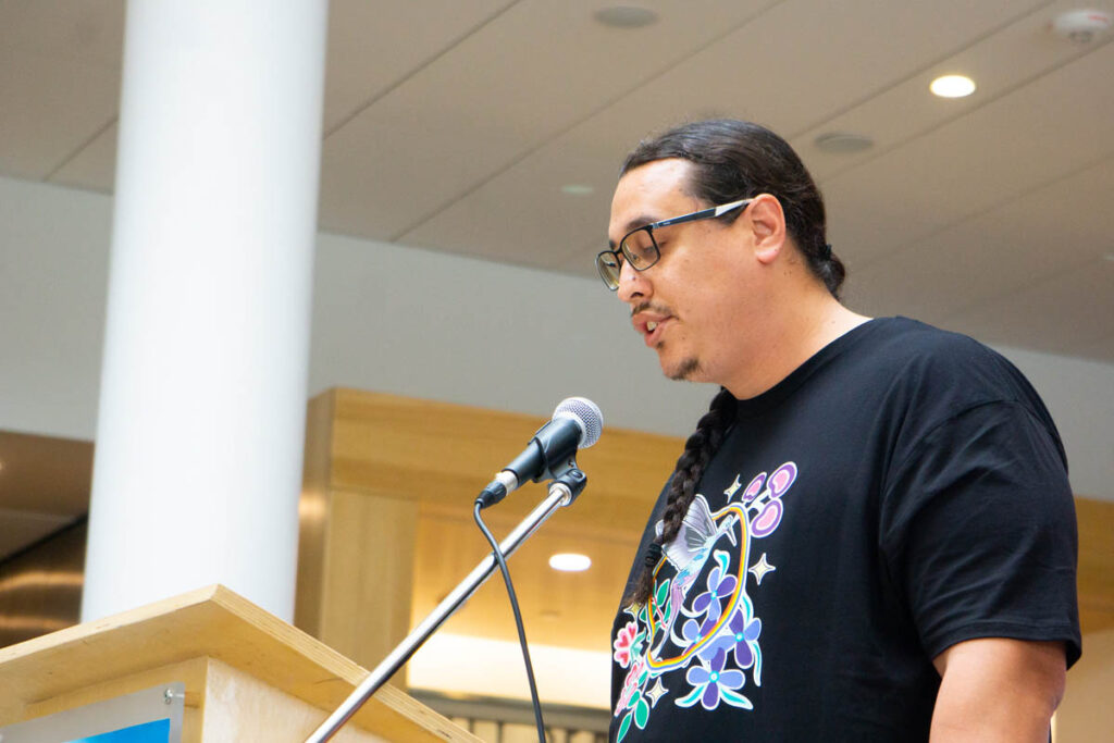 Man giving a speech from a podium