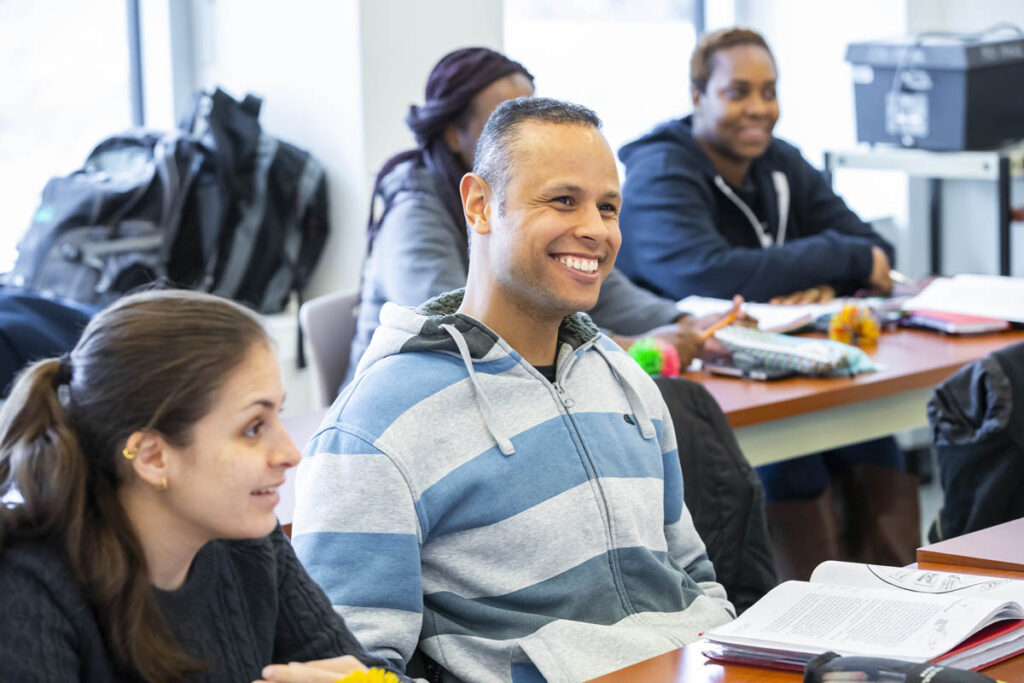 Smiling students sitting in a classroom