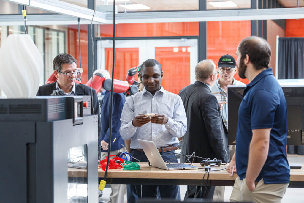 People milling around in a robotics lab