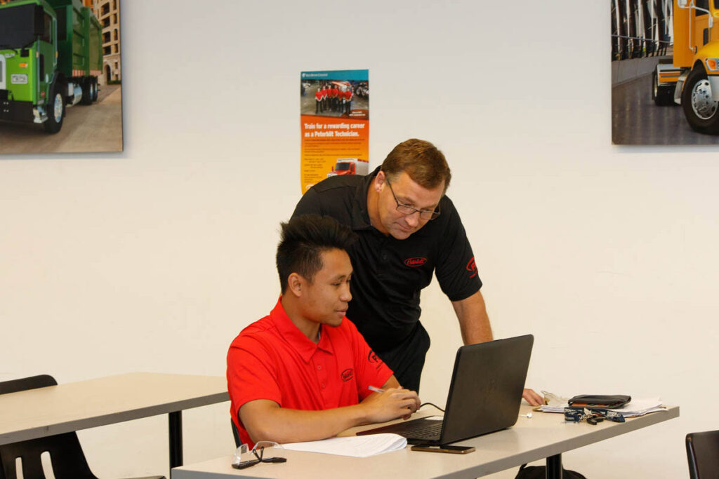 Instructor talking to student on a laptop