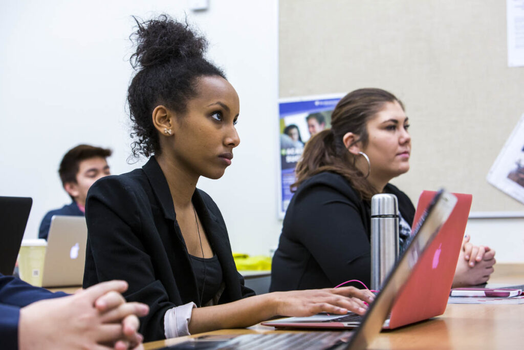 Students on laptops in a classroom