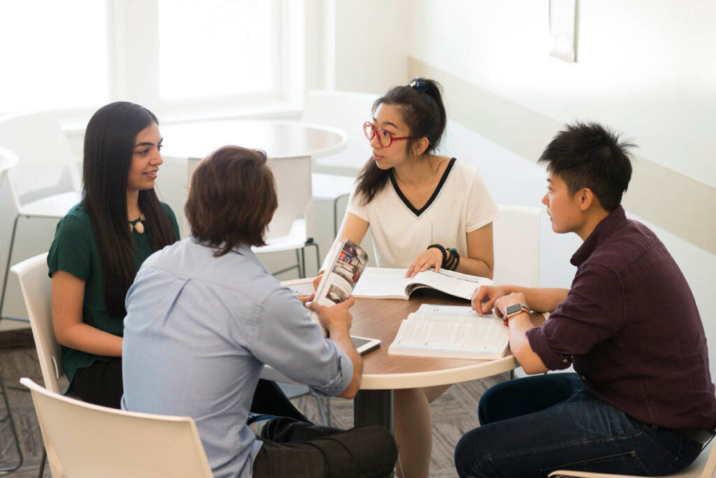 Four friends talking around a table