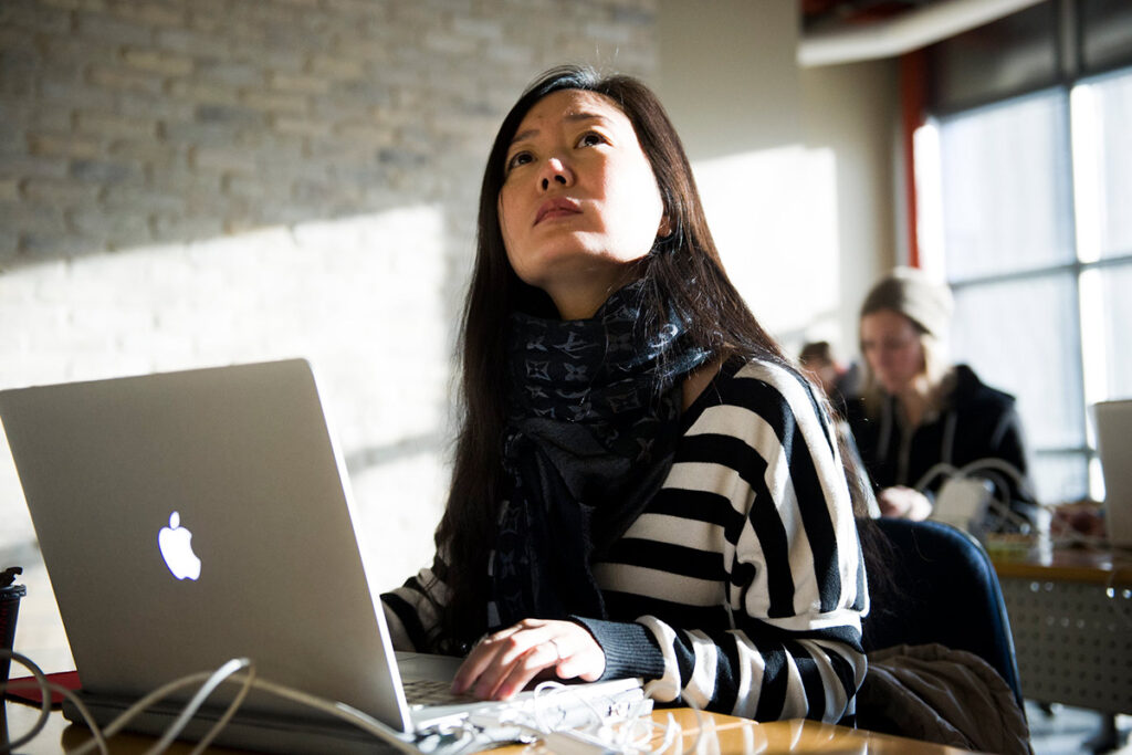 Girl sitting in a classroom with a laptop