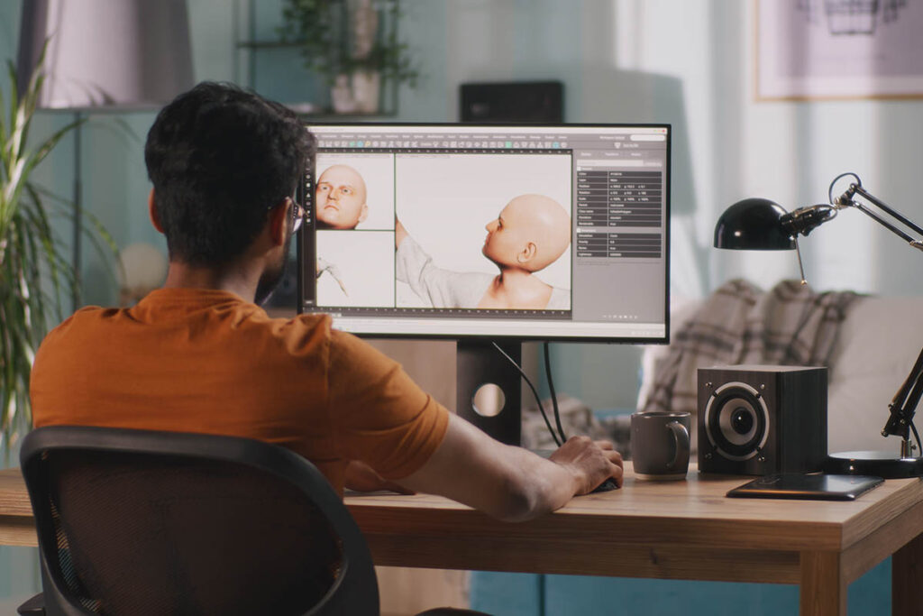 3D animator creating a a model of a person on a computer