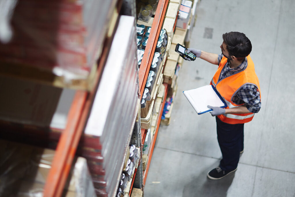 Man scanning inventory in a warehouse