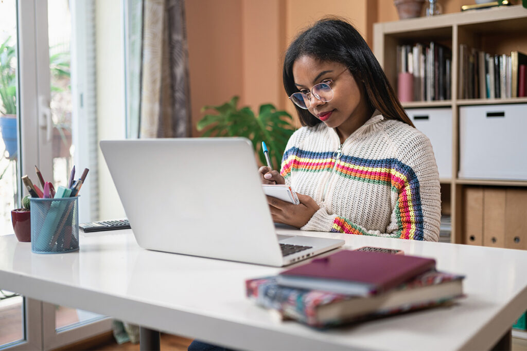 Woman working on a laptop in her home office