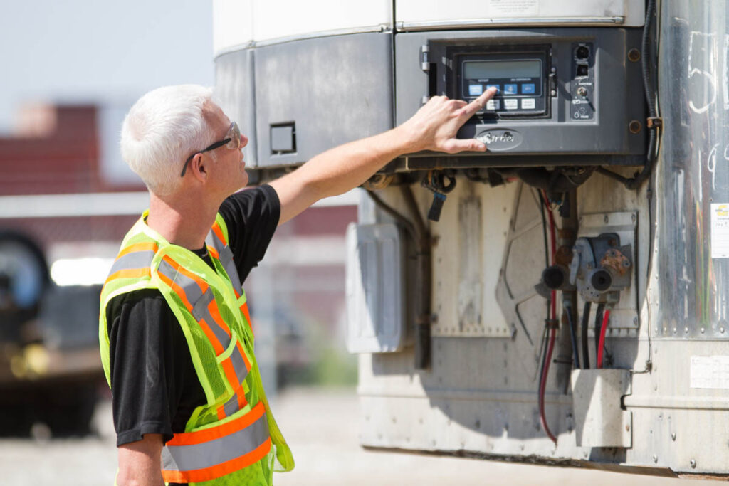 Man pushing buttons on a control panel outside