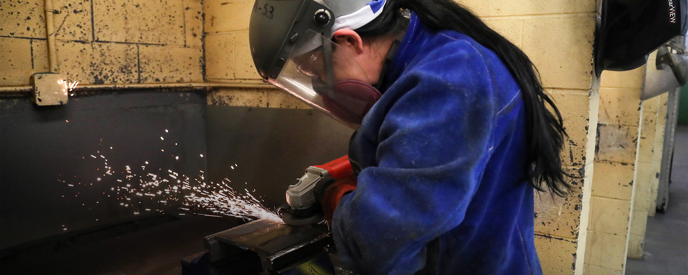 Person welding in welding shop