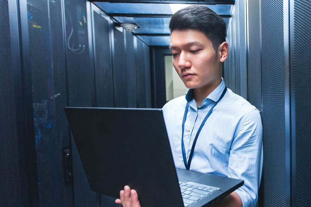 Man holding a tablet in a data centre
