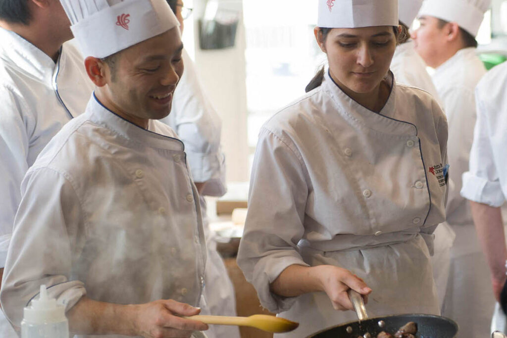 Two chefs cooking in a kitchen