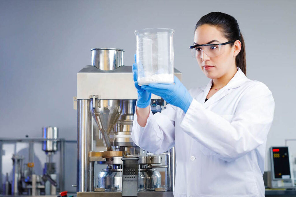 Woman holding beaker in lab