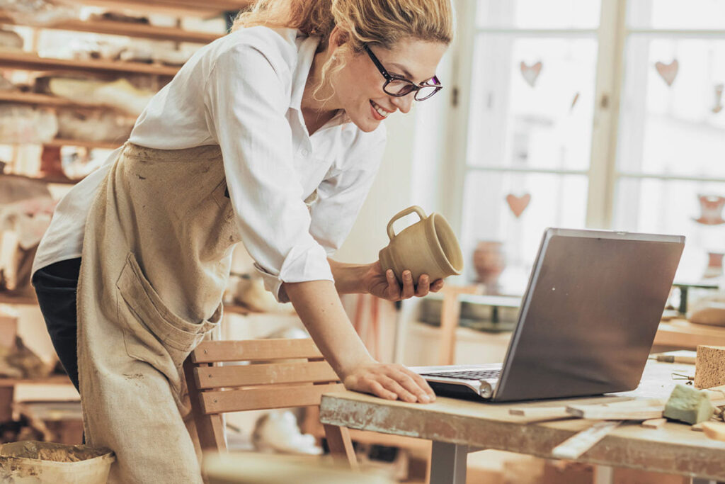 Woman standing in front of laptop