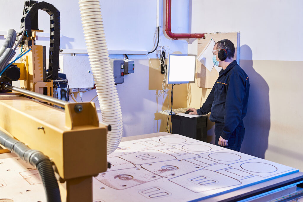 Man working in shop with large machinery