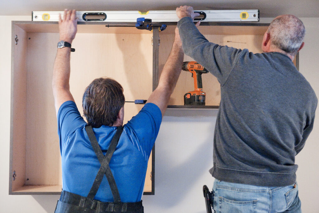 Carpenters installing kitchen cabinets 