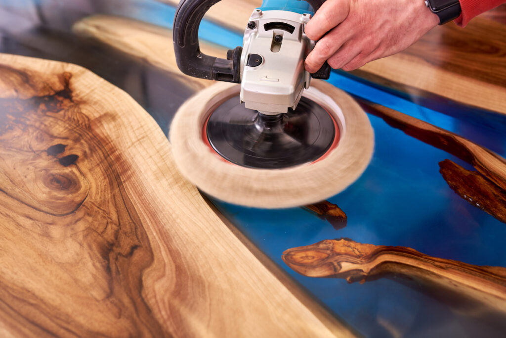 Person polishing a piece of wood