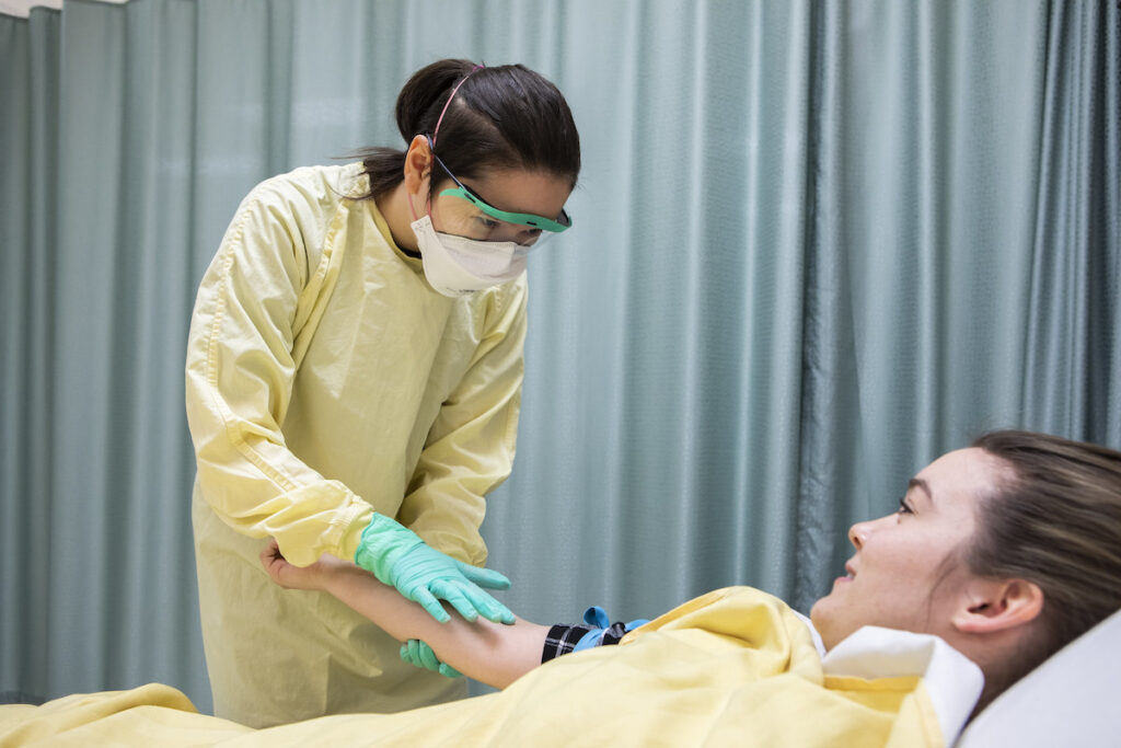 Nurse examining an injured patient's arm