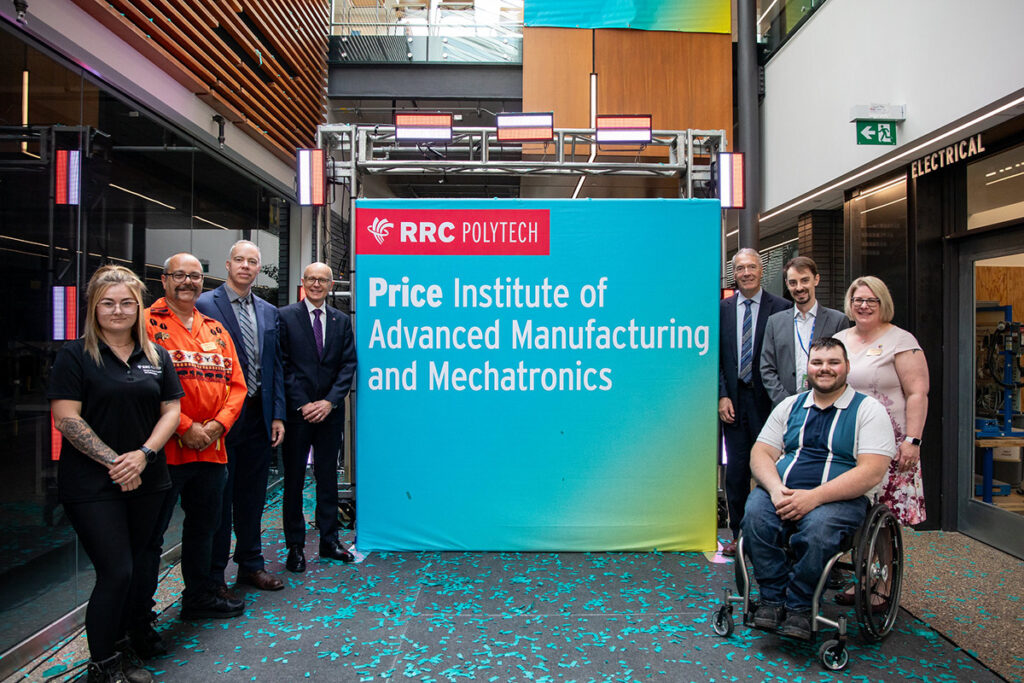 Dignitaries in front of a sign announcing the Price Institute of Advanced Manufacturing and Mechatronics