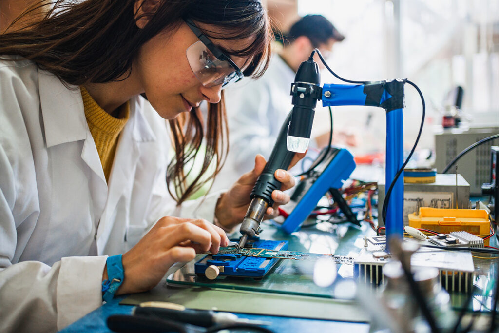 Woman soldering circuitboard 