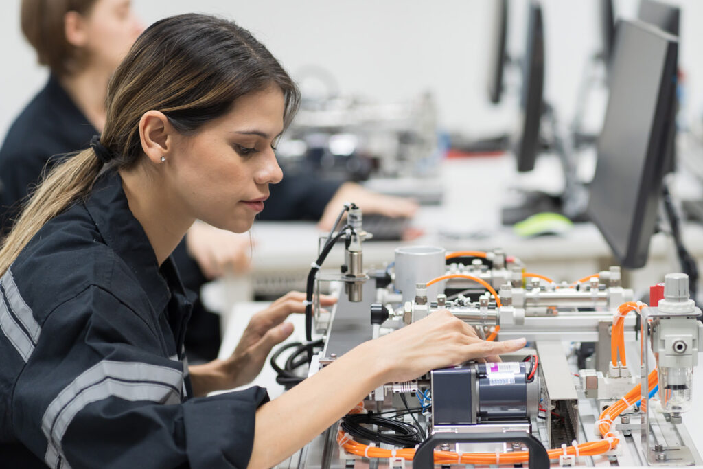 Woman working on circuitry for device