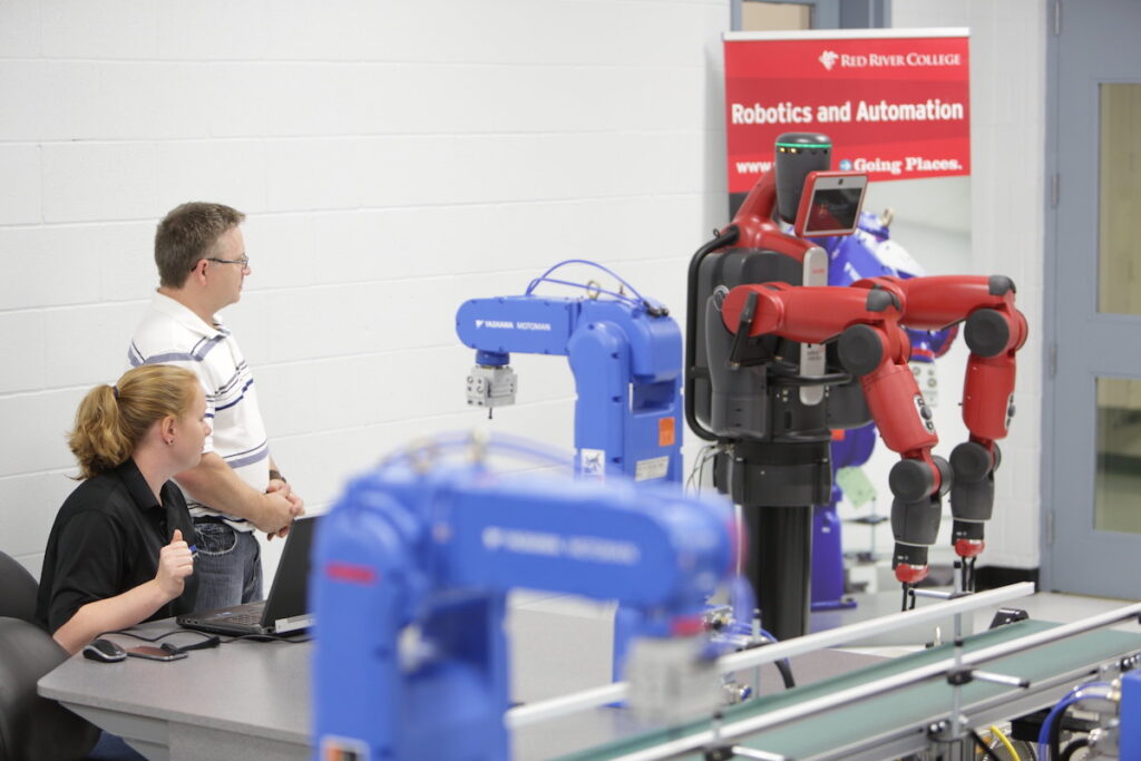 People watching robots in robotics lab