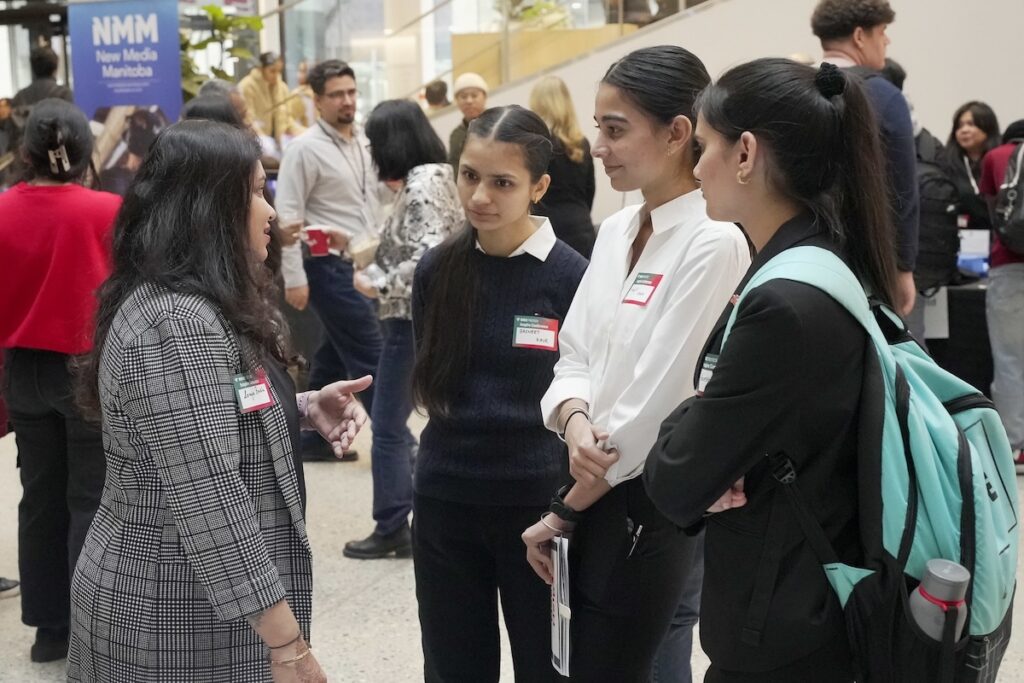 Students interacting with employer at a conference