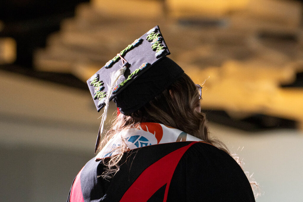 Graduate wearing cap and Indigenous stole