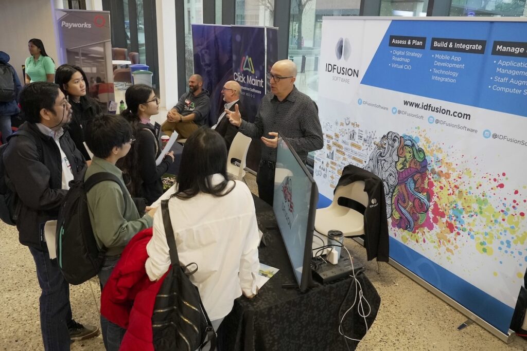 Students interacting with employer at a conference