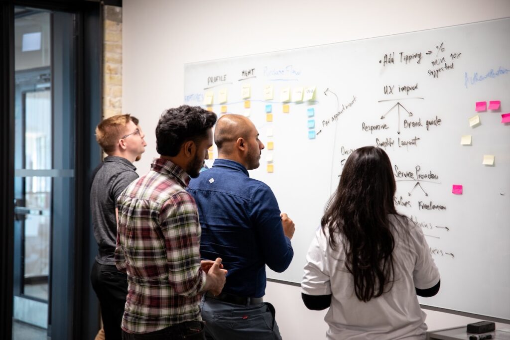 Students utilizing a white board working on a user experience project