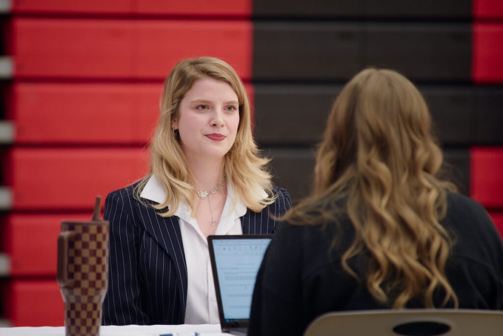 Woman at a business conference talking to another person