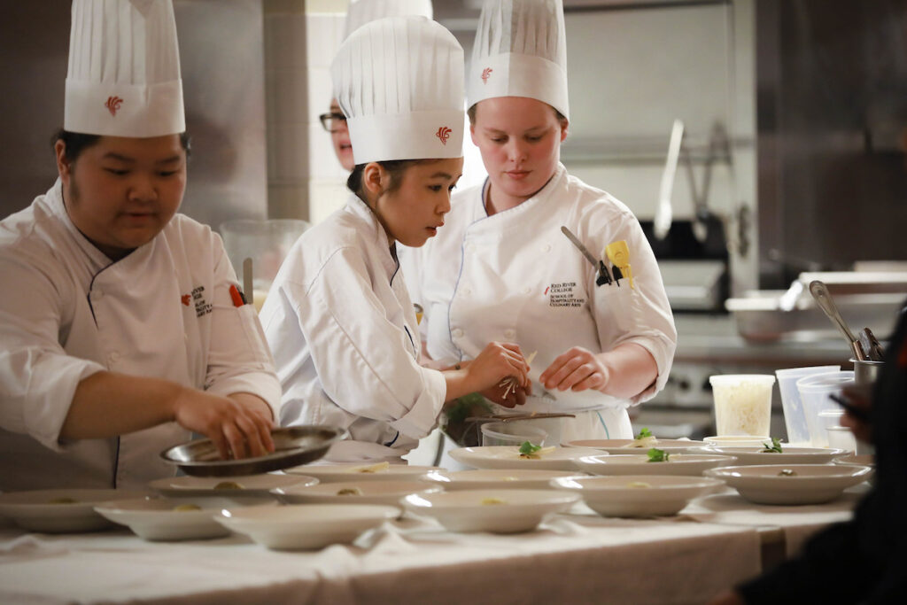 culinary students cooking in a kitchen