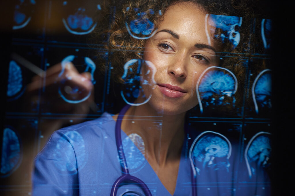 a female doctor or surgeon is analysing the digitally generated scans of a human brain