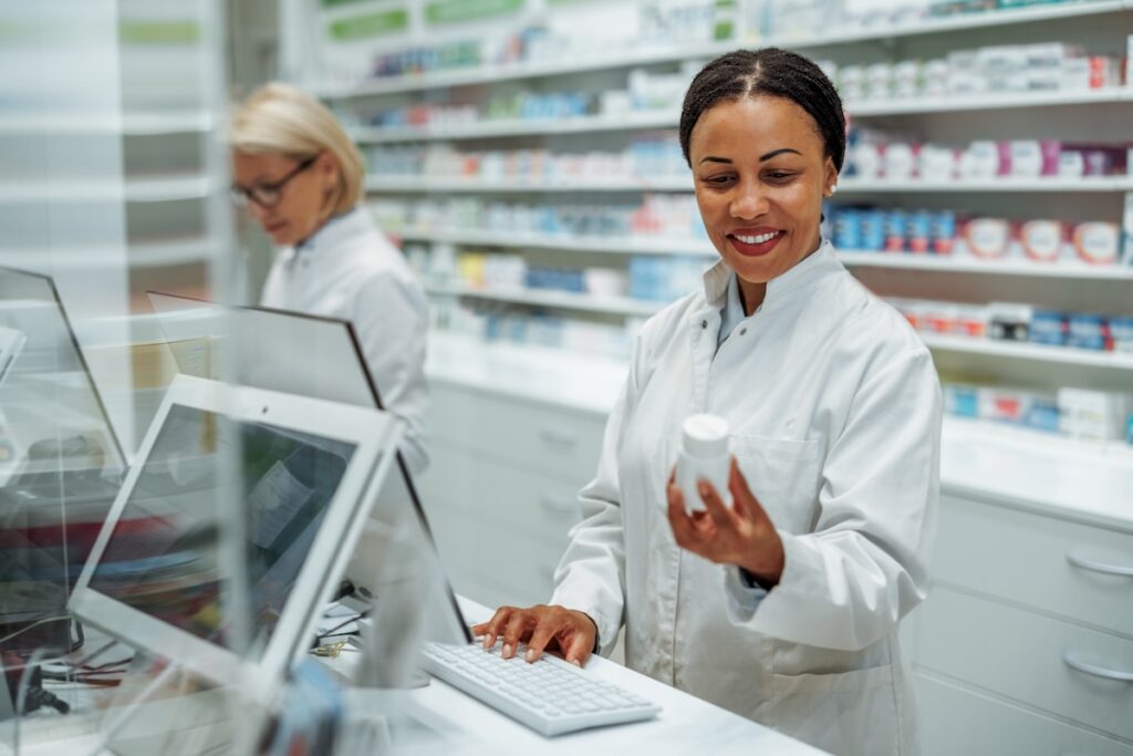 Smiling female pharmacist working at pharmacy store