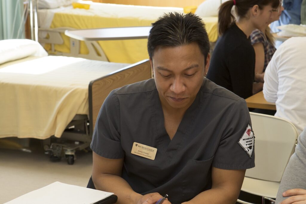 Nursing student participates in a clinical simulation exercise focused on patient assessment and care planning.